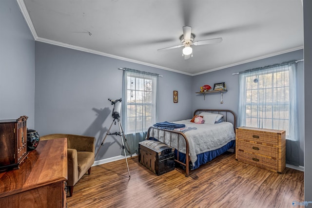 bedroom featuring ornamental molding, hardwood / wood-style flooring, ceiling fan, and multiple windows