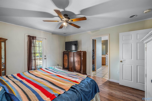 bedroom featuring access to exterior, ensuite bathroom, dark hardwood / wood-style flooring, crown molding, and ceiling fan