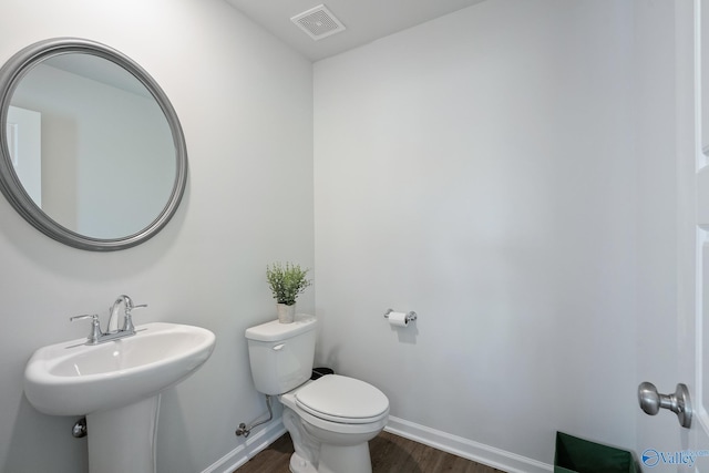 bathroom with sink, hardwood / wood-style floors, and toilet