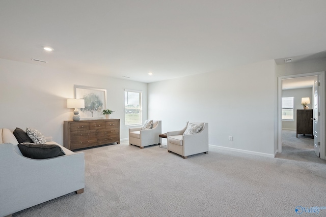 interior space with light carpet and a wealth of natural light