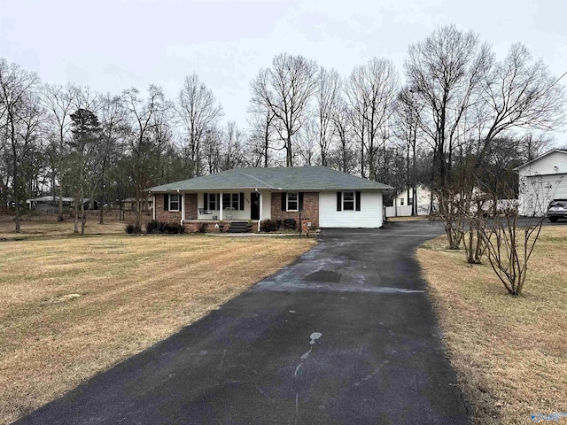 ranch-style home featuring a front yard and a porch