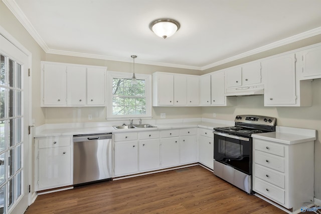 kitchen featuring appliances with stainless steel finishes, decorative light fixtures, white cabinetry, ornamental molding, and dark wood-type flooring