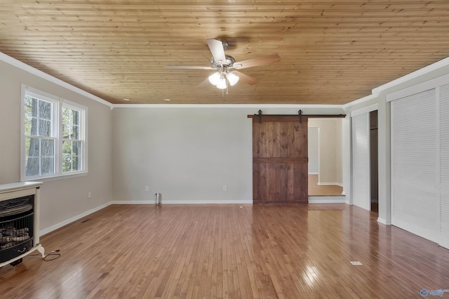 unfurnished living room featuring crown molding, a barn door, hardwood / wood-style floors, and wood ceiling