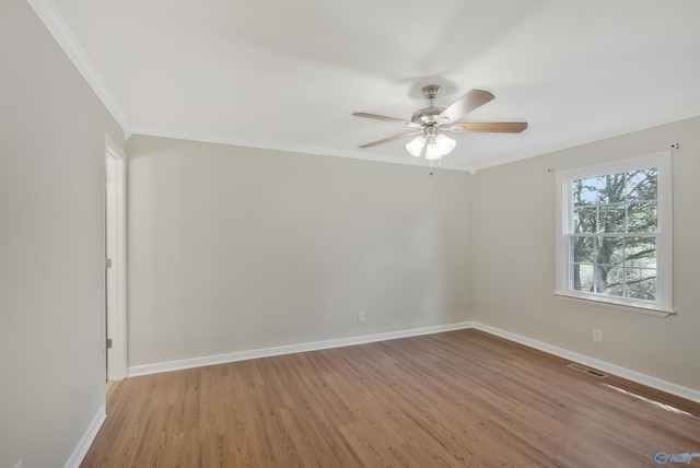 spare room featuring ornamental molding, ceiling fan, and light wood-type flooring