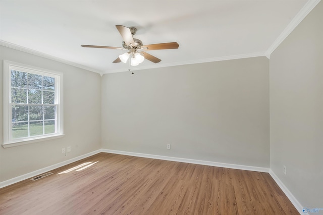 spare room featuring crown molding, ceiling fan, and light wood-type flooring