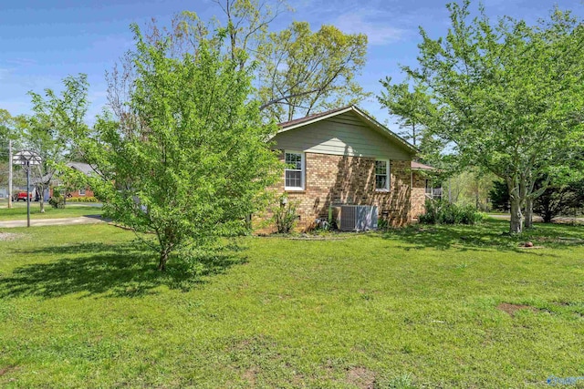 exterior space featuring a yard and central AC unit