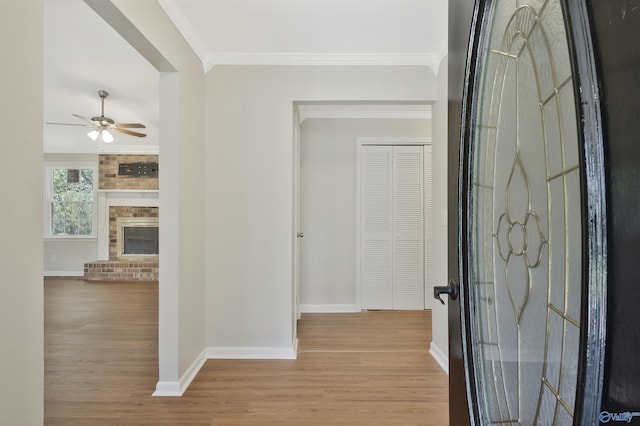 hall with crown molding and light wood-type flooring