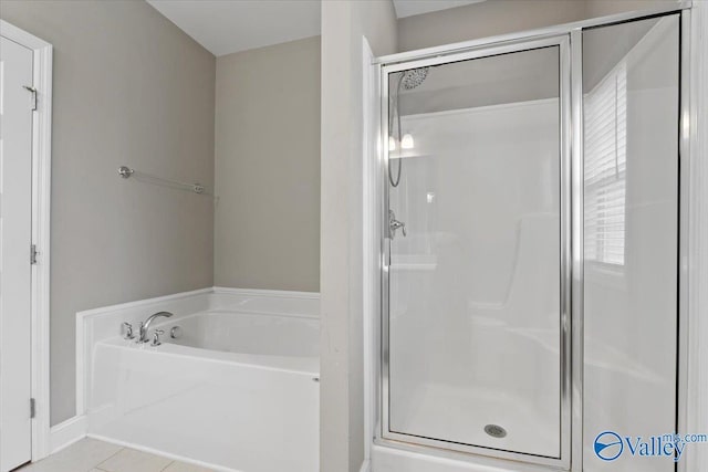 full bath with a stall shower, a bath, and tile patterned flooring