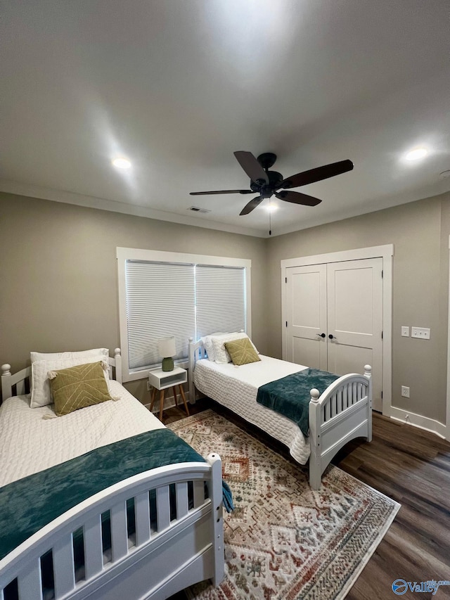 bedroom with ceiling fan, hardwood / wood-style flooring, and a closet