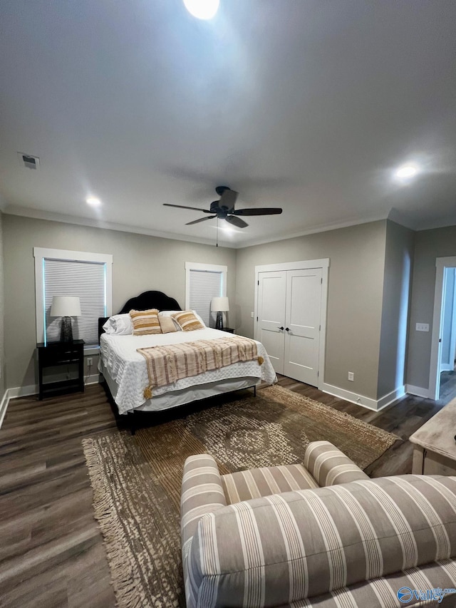 bedroom with dark hardwood / wood-style floors and ceiling fan