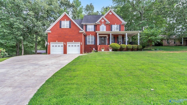 44 Jeff St, Scottsboro, AL 35769 - colonial house featuring brick siding, a garage, driveway, and a front lawn