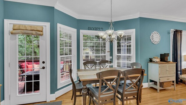 44 Jeff St, Scottsboro, AL 35769 - dining space featuring a chandelier, crown molding, and wood finished floors