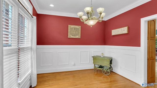 44 Jeff St, Scottsboro, AL 35769 - interior space featuring a chandelier, a wainscoted wall, light wood-type flooring, and ornamental molding