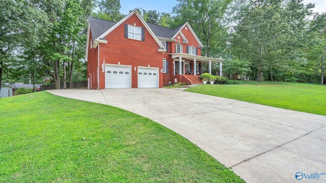 44 Jeff St, Scottsboro, AL 35769 - view of front facade with a porch, brick siding, driveway, and a garage