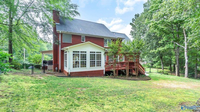 44 Jeff St, Scottsboro, AL 35769 - rear view of house with a fenced backyard, a gate, a wooden deck, a chimney, and stairway