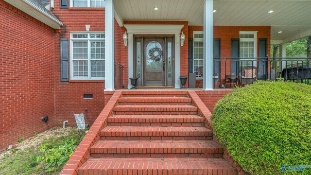 44 Jeff St, Scottsboro, AL 35769 - view of exterior entry featuring brick siding and a porch