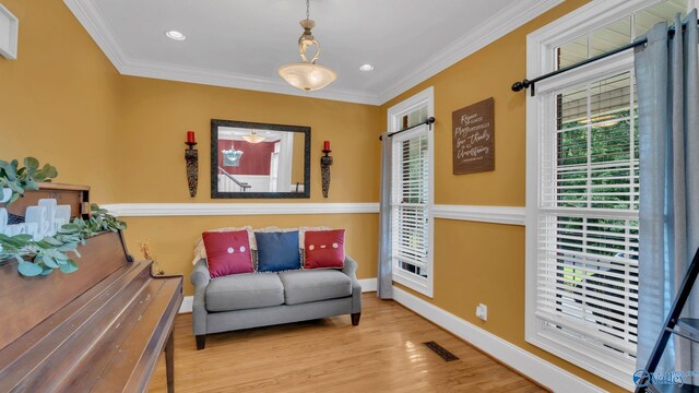 44 Jeff St, Scottsboro, AL 35769 - sitting room with plenty of natural light, ornamental molding, wood finished floors, and recessed lighting