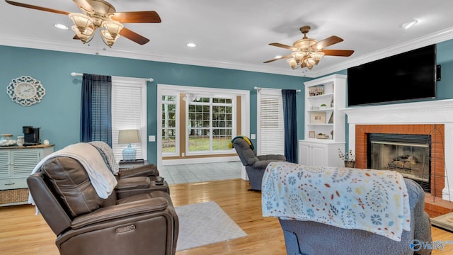 44 Jeff St, Scottsboro, AL 35769 - living area featuring ceiling fan, light wood-style flooring, a fireplace, crown molding, and recessed lighting