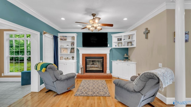 44 Jeff St, Scottsboro, AL 35769 - living area with a fireplace, ceiling fan, ornamental molding, wood finished floors, and recessed lighting