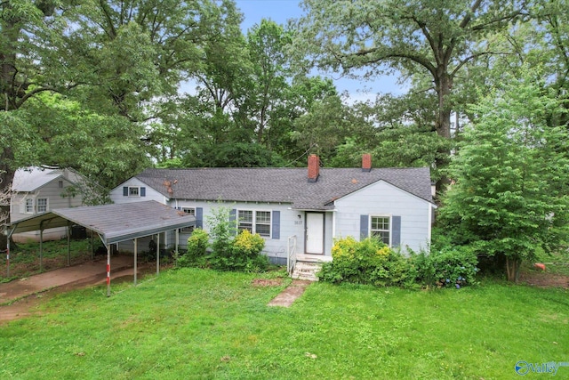 1617 7th St SE, Decatur, AL 35601 - view of front of house with a chimney, a front yard, a carport, and a shingled roof