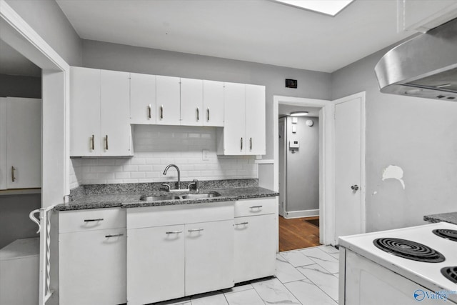 1617 7th St SE, Decatur, AL 35601 - kitchen with a sink, wall chimney range hood, white cabinetry, electric range, and tasteful backsplash