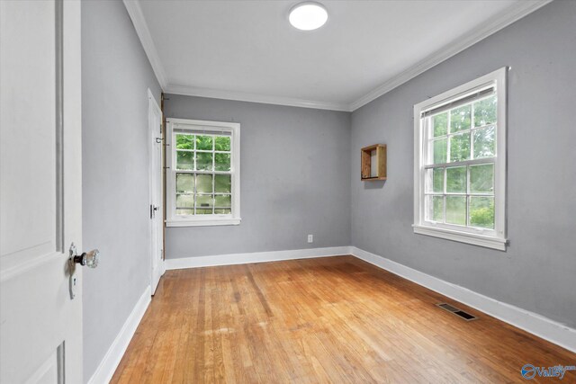 1617 7th St SE, Decatur, AL 35601 - spare room featuring healthy amount of natural light, light wood-style floors, ornamental molding, and baseboards