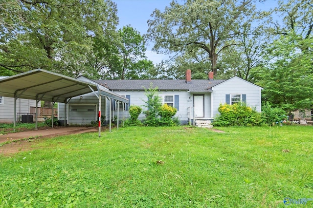 1617 7th St SE, Decatur, AL 35601 - view of front of home with a chimney, a front lawn, central AC, roof with shingles, and a detached carport