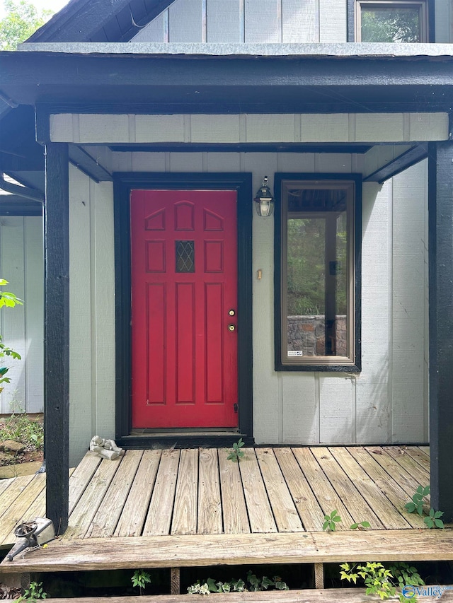 view of exterior entry with a wooden deck