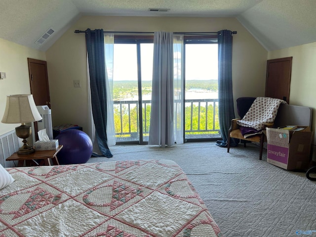 bedroom featuring carpet floors, a textured ceiling, access to outside, and vaulted ceiling