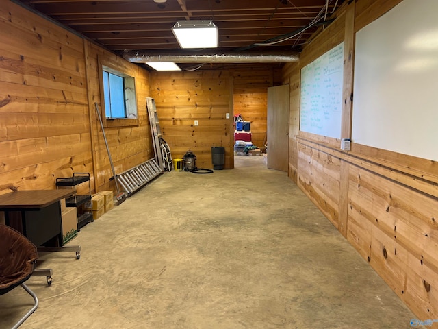 basement featuring wood walls