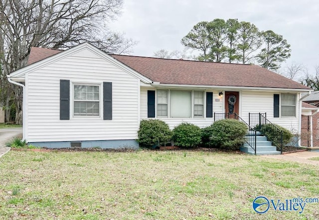 ranch-style house with crawl space, a front lawn, and roof with shingles