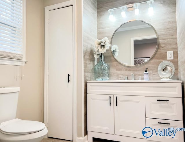 bathroom featuring vanity and toilet