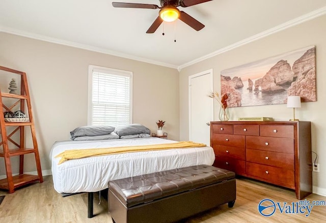 bedroom with a ceiling fan, baseboards, crown molding, and light wood finished floors