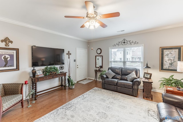 living room with ceiling fan, wood-type flooring, and crown molding