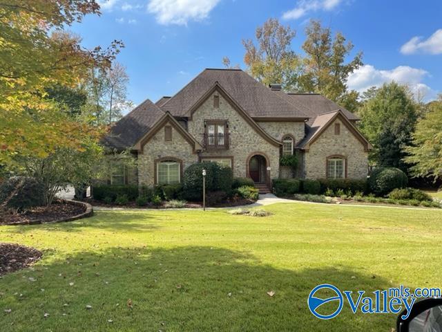 french provincial home featuring a front yard