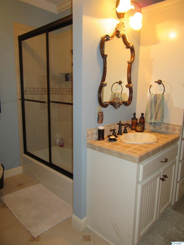 bathroom with ornamental molding, vanity, and tile patterned floors