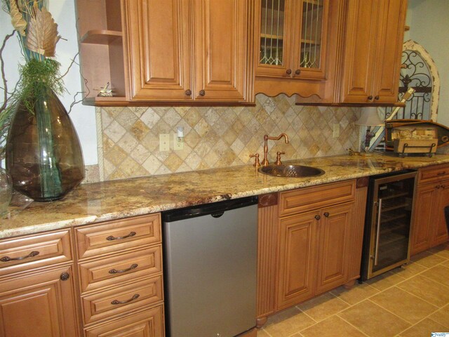 kitchen with wine cooler, stainless steel dishwasher, light stone countertops, decorative backsplash, and sink