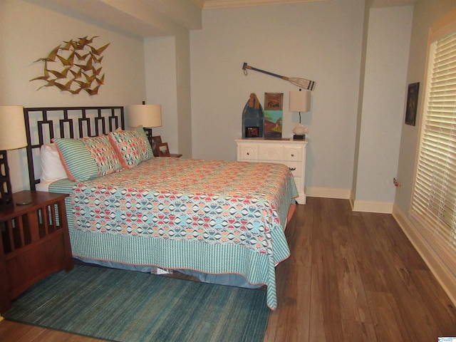 bedroom with dark wood-type flooring