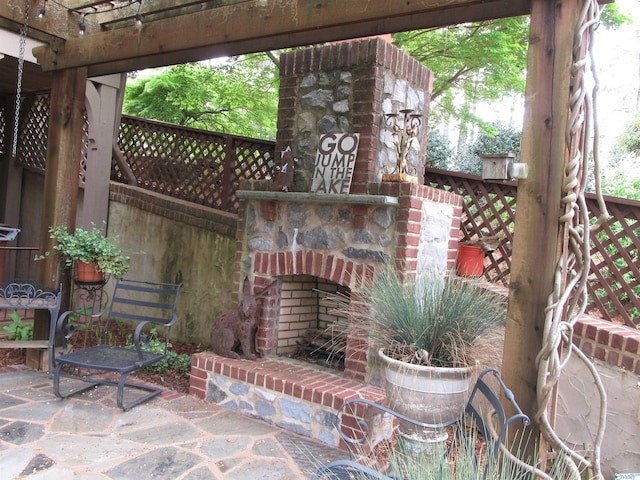 view of patio featuring exterior fireplace