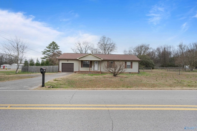 single story home featuring a garage and a front yard