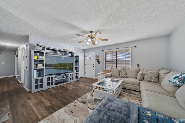 living room with a textured ceiling, dark hardwood / wood-style floors, and ceiling fan