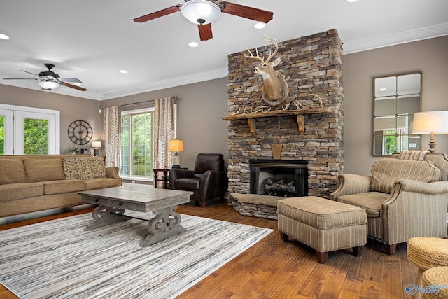 living room with a fireplace, dark hardwood / wood-style flooring, and ceiling fan