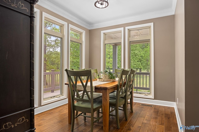 dining space featuring crown molding and hardwood / wood-style floors