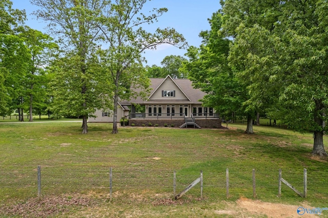 view of front of house with a front yard and covered porch