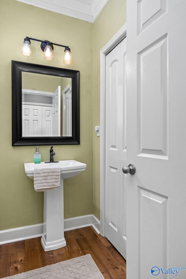 bathroom with ornamental molding and hardwood / wood-style floors