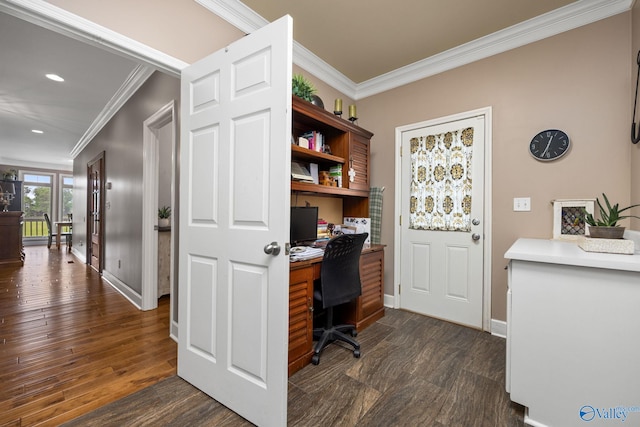 office with built in desk, crown molding, and dark wood-type flooring