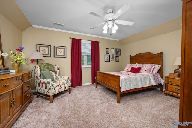 carpeted bedroom with ceiling fan, vaulted ceiling, and crown molding