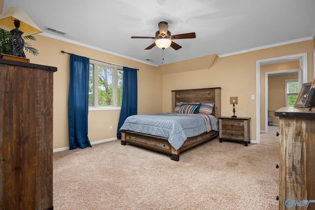 bedroom with crown molding, ceiling fan, and light colored carpet