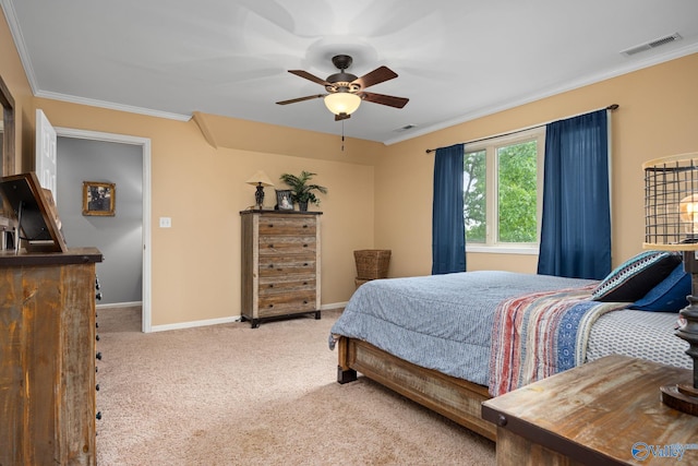 carpeted bedroom featuring crown molding and ceiling fan