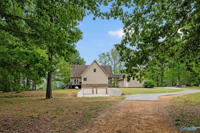 view of property exterior with a garage and a yard